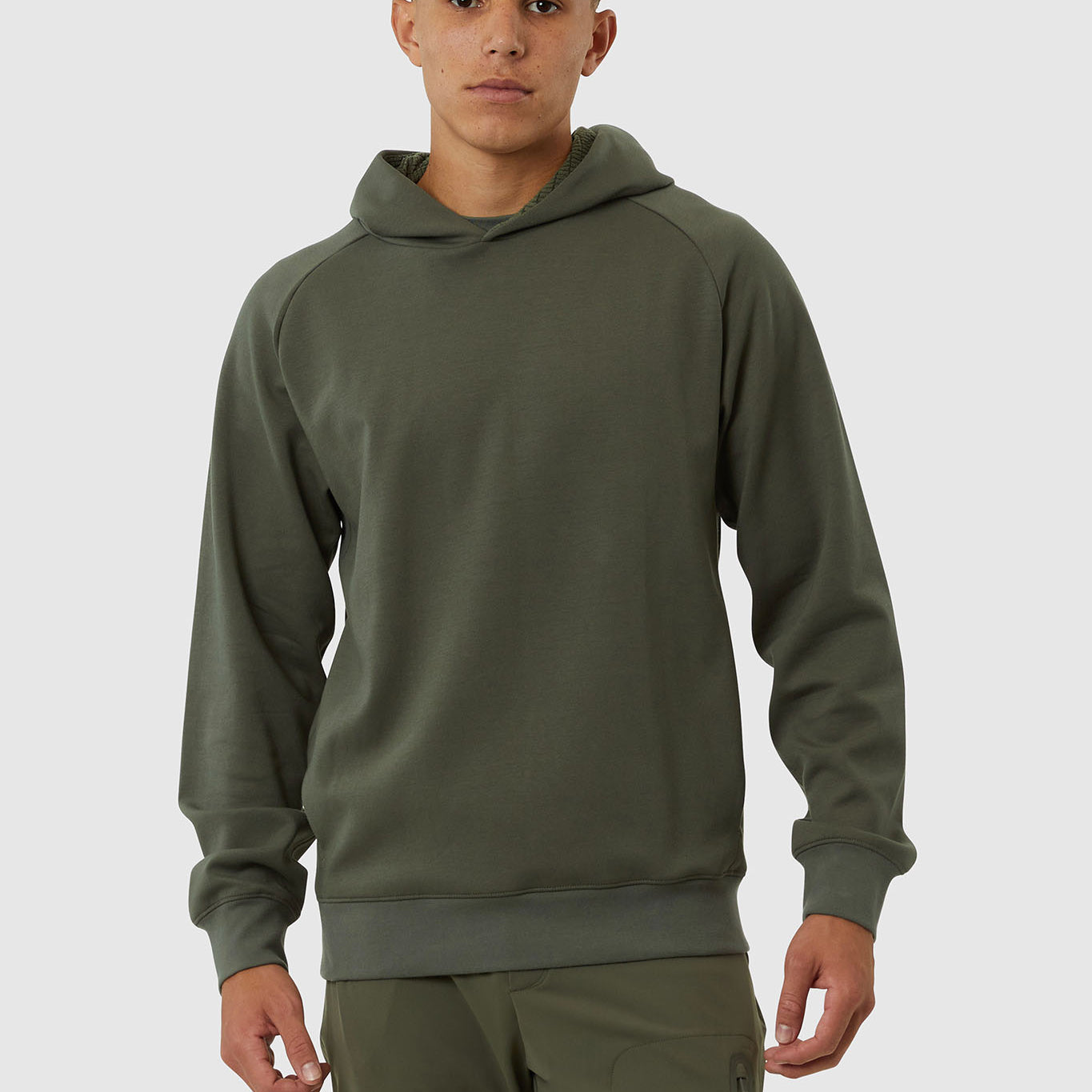 Man wearing a green hoodie and pants on a white background